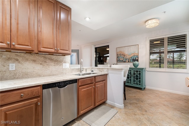 kitchen with dishwasher, decorative backsplash, sink, light tile patterned flooring, and light stone countertops