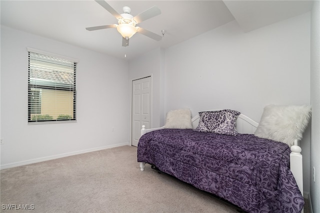 bedroom with a closet, ceiling fan, and carpet floors