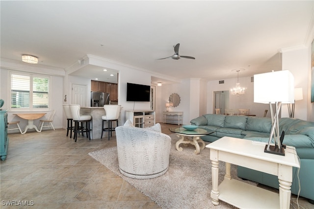 living room with ornamental molding and ceiling fan with notable chandelier