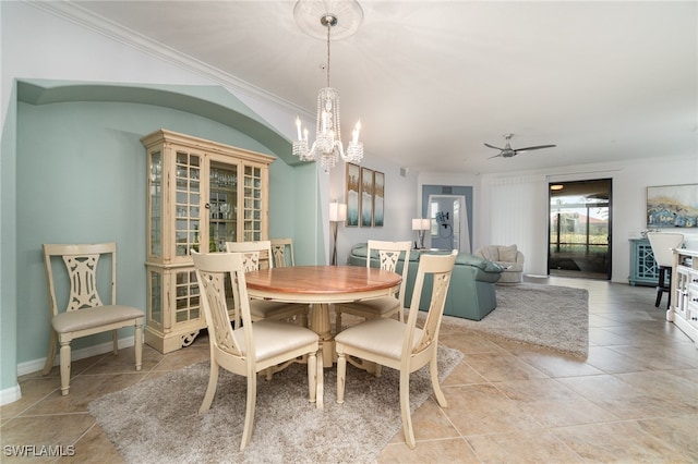 tiled dining space with ornamental molding and ceiling fan with notable chandelier