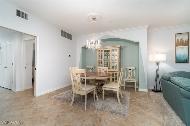 dining area featuring ornamental molding and a chandelier