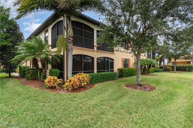 rear view of property featuring a yard