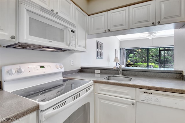 kitchen with white appliances, white cabinetry, and sink