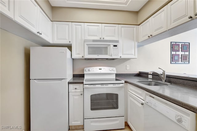 kitchen with sink, white cabinets, and white appliances