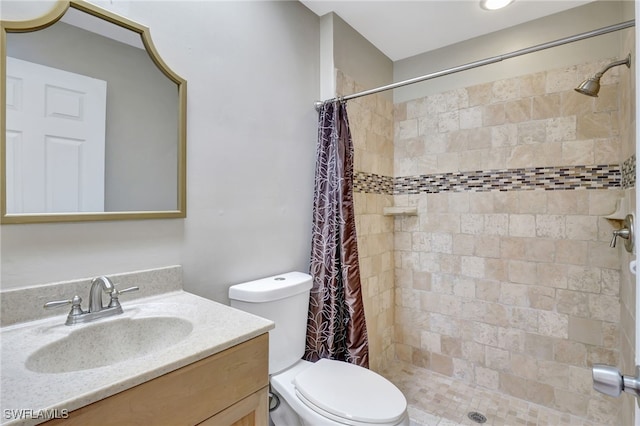 bathroom with toilet, vanity, and a shower with shower curtain