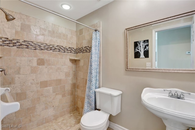 bathroom featuring sink, toilet, and walk in shower