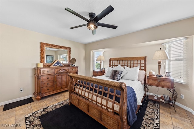 bedroom with multiple windows, ceiling fan, and light tile patterned floors