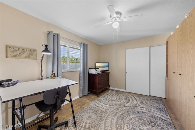 tiled office space featuring ceiling fan