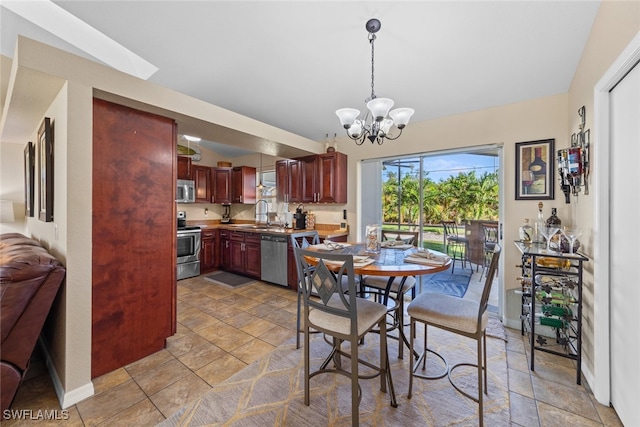 dining area with sink and a chandelier