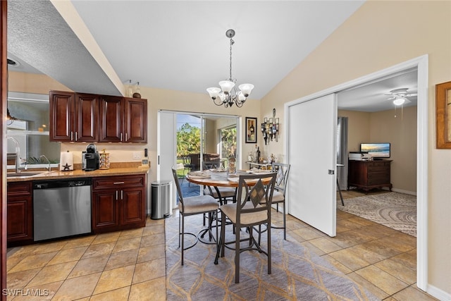 kitchen with stainless steel dishwasher, pendant lighting, vaulted ceiling, light tile patterned floors, and ceiling fan with notable chandelier