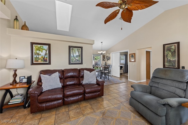 tiled living room with high vaulted ceiling and ceiling fan with notable chandelier