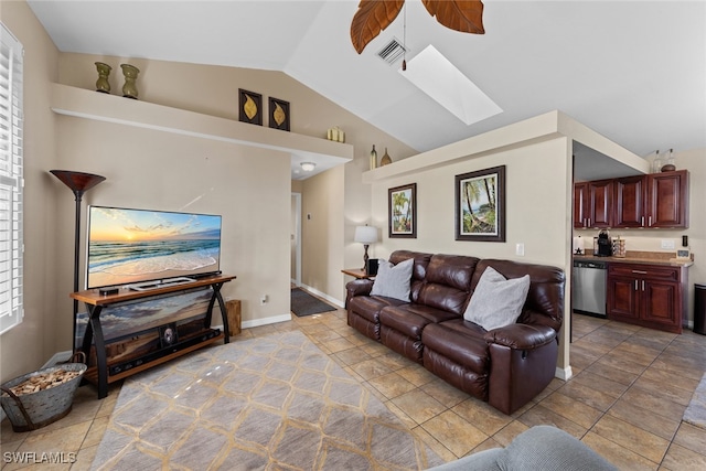 living room featuring tile patterned floors and vaulted ceiling with skylight