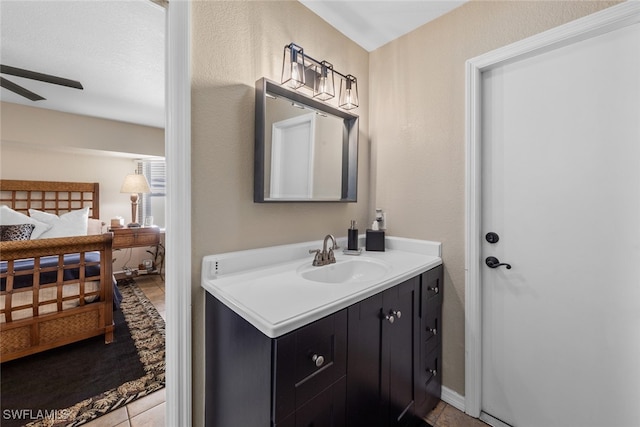 bathroom with tile patterned flooring, vanity, and ceiling fan