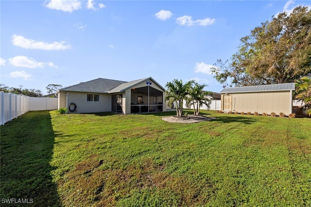 rear view of house with a yard and a sunroom