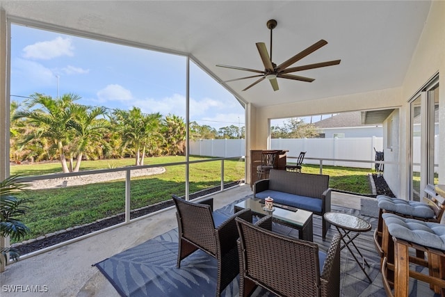 sunroom with ceiling fan and lofted ceiling