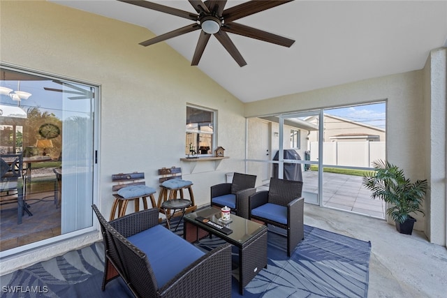 sunroom / solarium with ceiling fan and vaulted ceiling