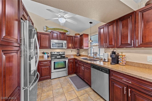 kitchen with sink, hanging light fixtures, a textured ceiling, lofted ceiling, and appliances with stainless steel finishes