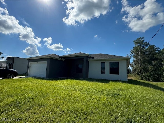 133 Greenbriar Blvd, Lehigh Acres, FL 33972 - view of front of house featuring stucco siding, a garage, and a front lawn