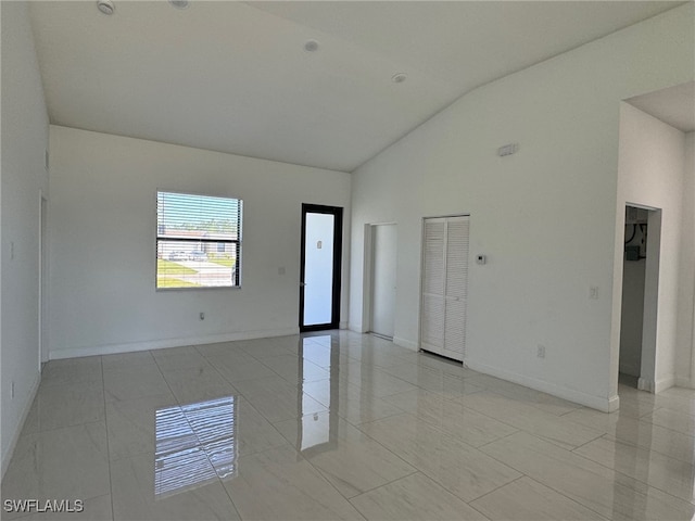 spare room featuring vaulted ceiling