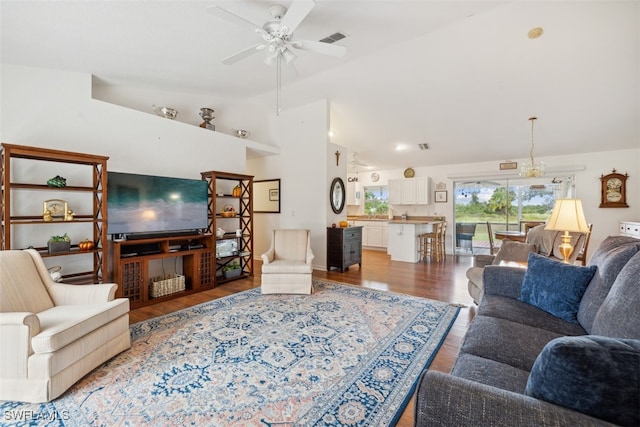 living room featuring lofted ceiling, hardwood / wood-style flooring, and ceiling fan