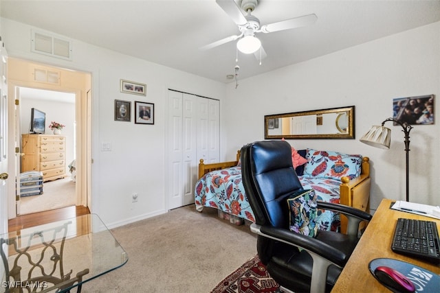 carpeted office space featuring ceiling fan