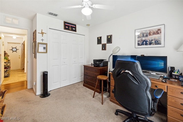 home office featuring light colored carpet and ceiling fan