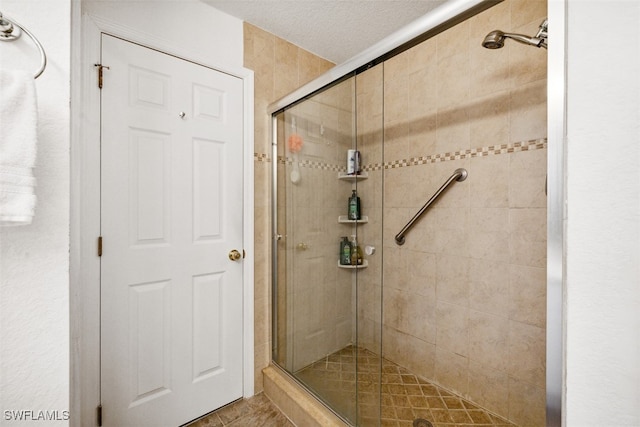 bathroom featuring walk in shower and a textured ceiling