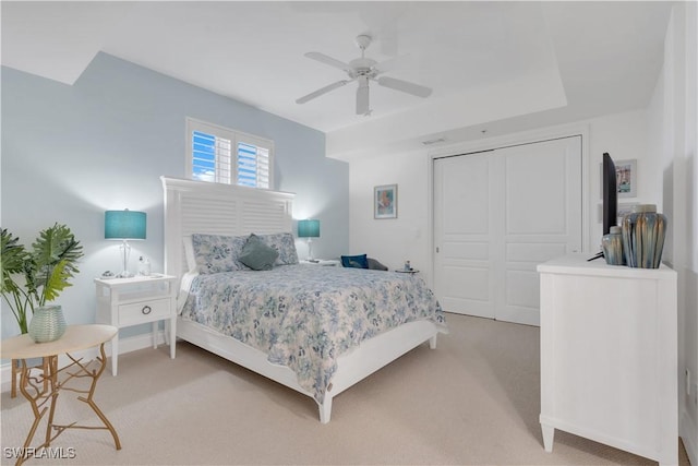 carpeted bedroom with a closet and ceiling fan