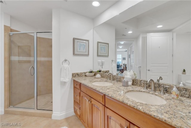 bathroom with tile patterned flooring, vanity, toilet, and walk in shower