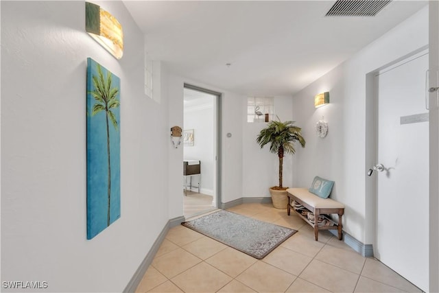 hall featuring light tile patterned floors