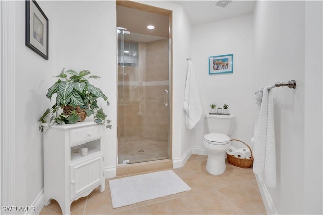 bathroom featuring toilet, tile patterned floors, and a shower with shower door