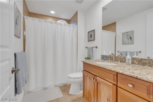 bathroom featuring tile patterned flooring, vanity, and toilet