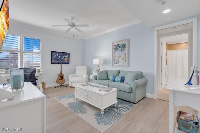 living room with light wood-type flooring, ceiling fan, and ornamental molding