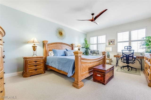 bedroom with carpet flooring, ceiling fan, and crown molding