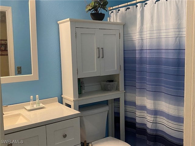 bathroom featuring vanity, toilet, and a shower with curtain