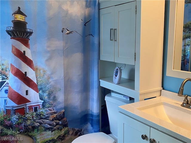 bathroom with vanity, toilet, and a shower with curtain