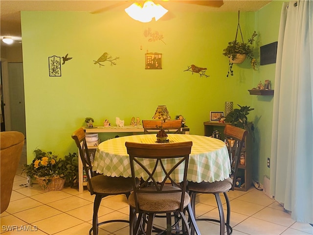 tiled dining area with ceiling fan