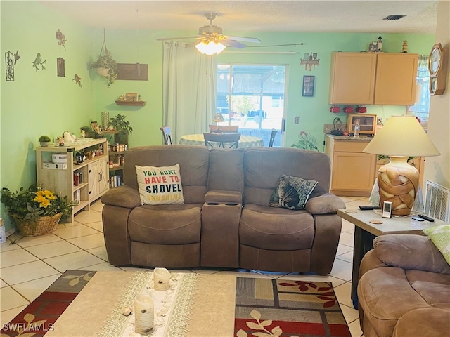 tiled living room with ceiling fan