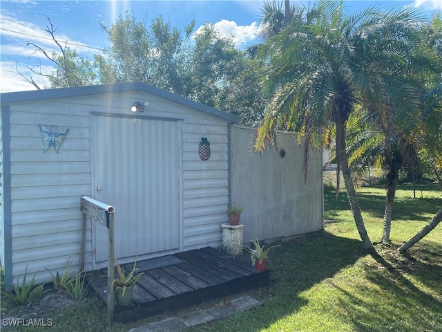 view of outbuilding featuring a lawn