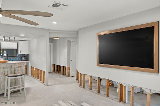 living room with bar and ceiling fan