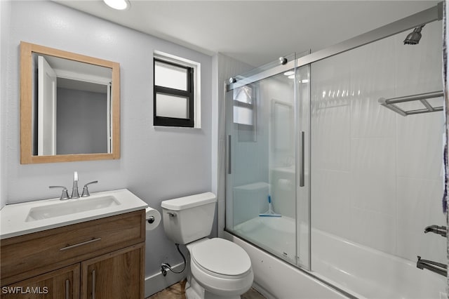 435 Donora Blvd, Fort Myers Beach, FL 33931 - bathroom featuring vanity, shower / bath combination with glass door, baseboards, and toilet