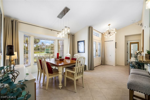 tiled dining area featuring a notable chandelier and vaulted ceiling