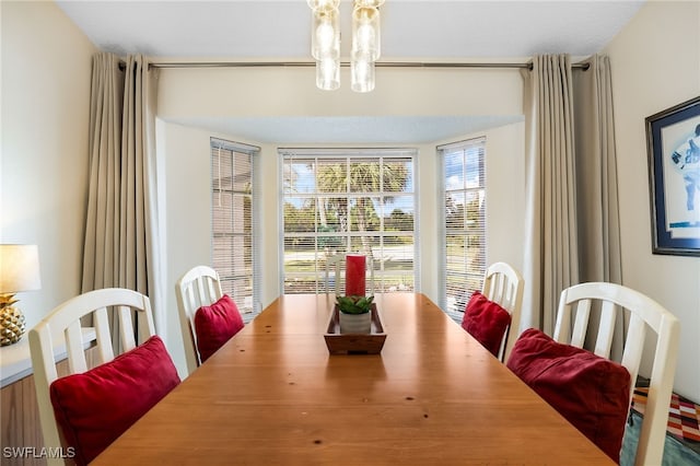 dining room with a textured ceiling and an inviting chandelier