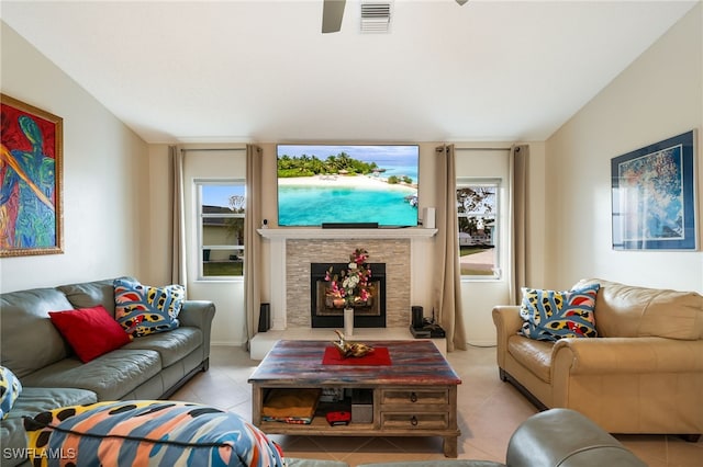 living room with a fireplace and light tile patterned floors