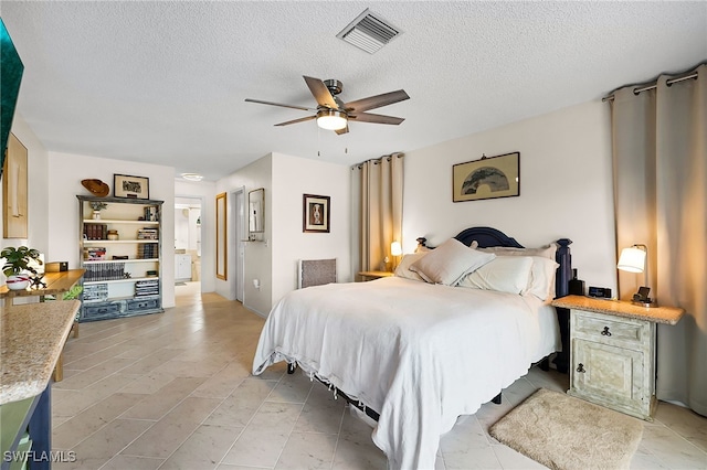 bedroom featuring a textured ceiling and ceiling fan