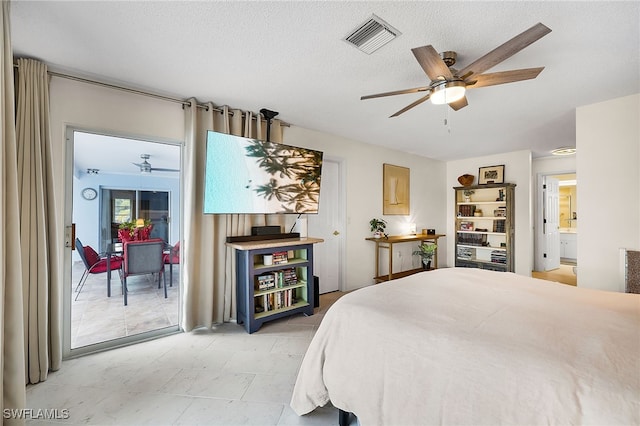 bedroom with connected bathroom, ceiling fan, and a textured ceiling