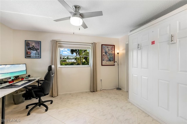 office space with a textured ceiling and ceiling fan