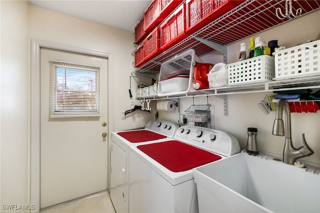 washroom with sink and washing machine and dryer