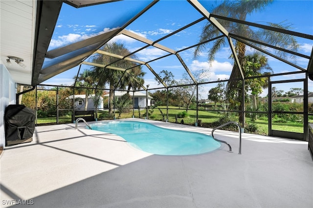 view of swimming pool featuring area for grilling, a patio, and a lanai