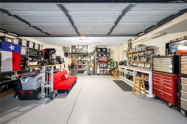 garage featuring a workshop area and water heater